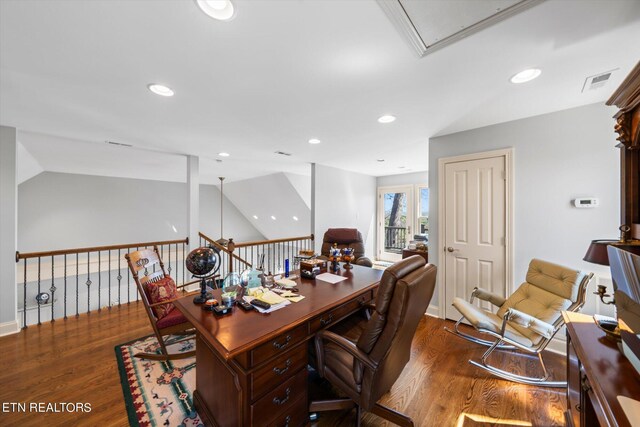 home office with lofted ceiling and dark hardwood / wood-style flooring