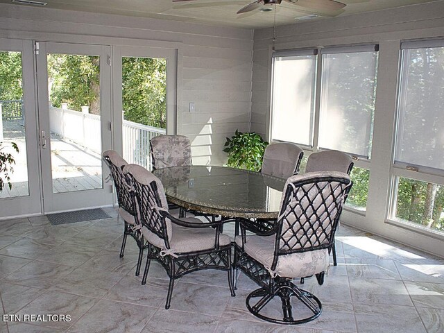 sunroom featuring ceiling fan and french doors