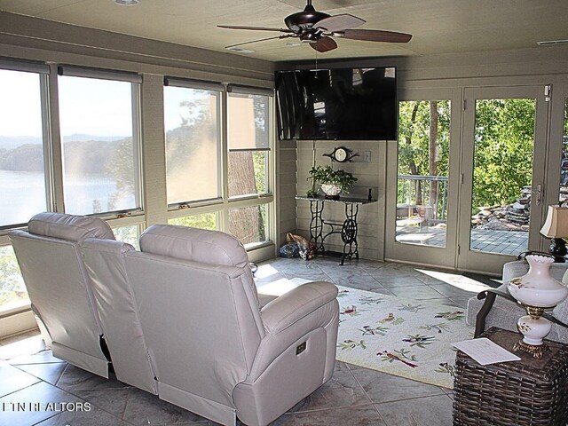 living room featuring plenty of natural light and ceiling fan