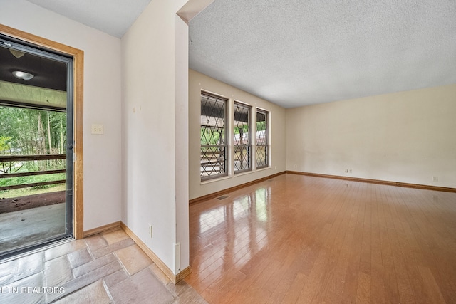 interior space with a textured ceiling and light wood-type flooring