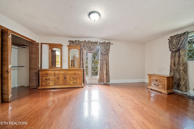 unfurnished bedroom featuring a textured ceiling and wood-type flooring