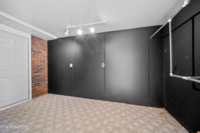 interior space with track lighting and light carpet