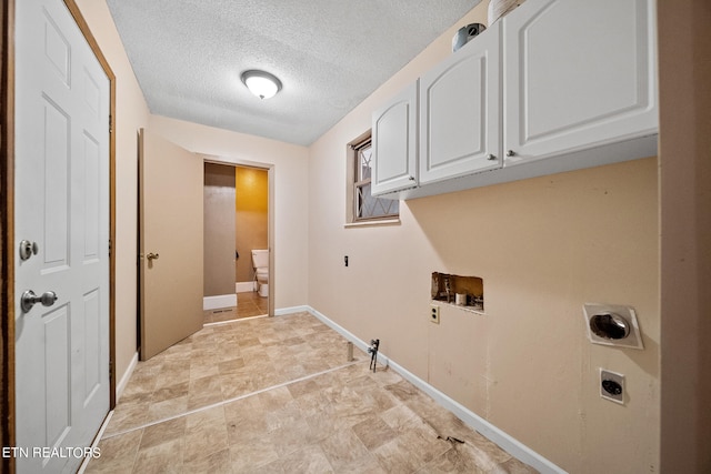 washroom with a textured ceiling, cabinets, washer hookup, and hookup for an electric dryer