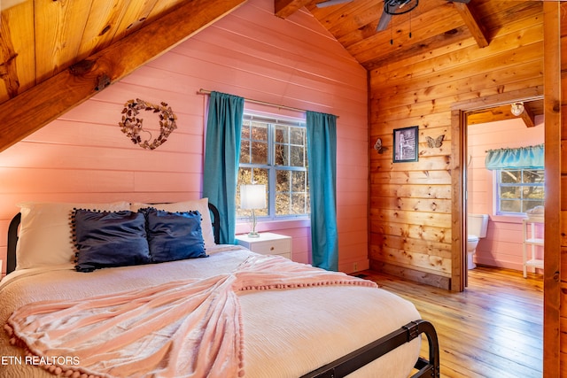 bedroom featuring wooden ceiling, vaulted ceiling with beams, light hardwood / wood-style floors, and wood walls