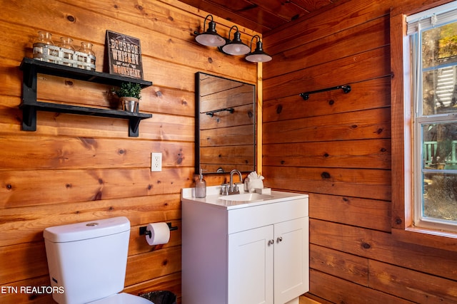 bathroom with vanity, wooden walls, toilet, and wood ceiling