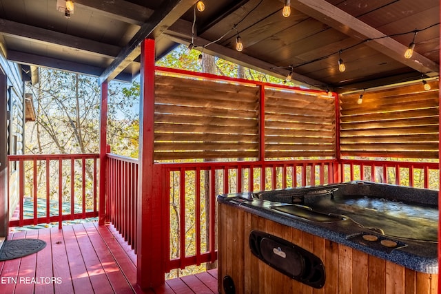 wooden terrace featuring a hot tub