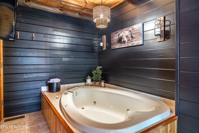 bathroom with wood ceiling, wooden walls, tile patterned flooring, and a tub