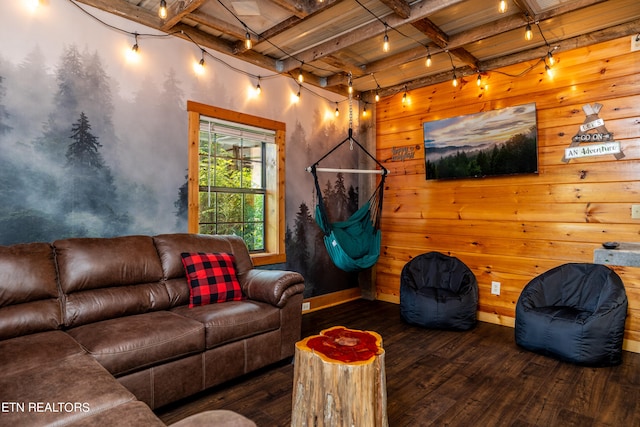 living room with rail lighting, wooden walls, beam ceiling, and dark hardwood / wood-style flooring