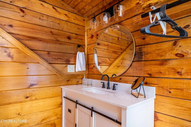 bathroom with wooden ceiling, wood walls, and vanity