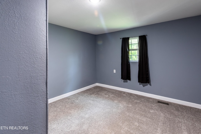 empty room featuring carpet flooring