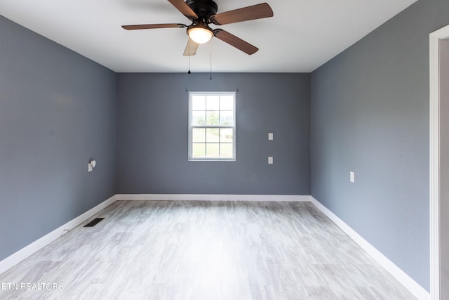 empty room featuring light hardwood / wood-style flooring and ceiling fan