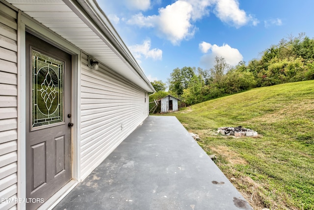 view of patio / terrace featuring a storage unit