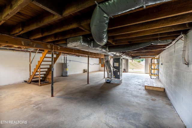 basement featuring heating unit and water heater