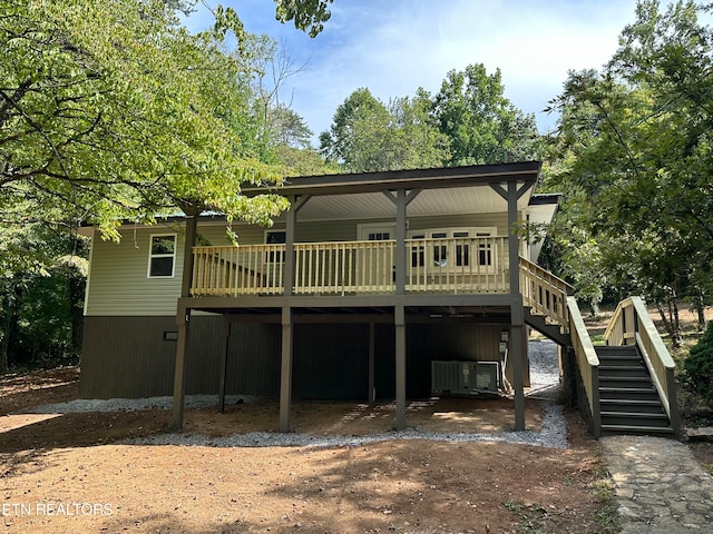 back of property featuring cooling unit and a wooden deck