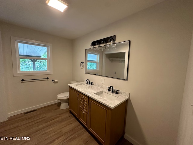 bathroom featuring hardwood / wood-style floors, toilet, and vanity