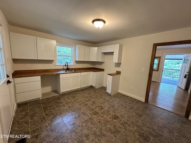 kitchen with white cabinets, dark hardwood / wood-style flooring, and sink