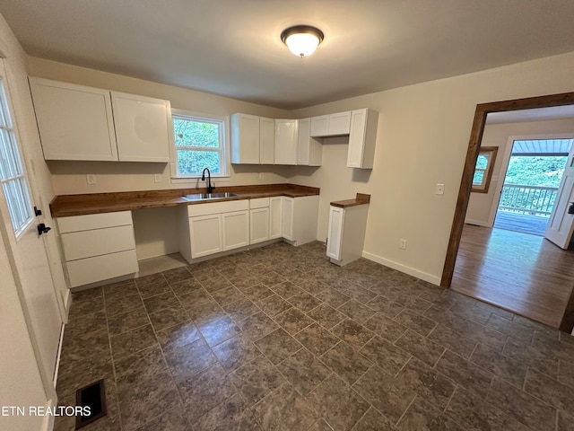 kitchen featuring sink, dark hardwood / wood-style floors, and white cabinetry