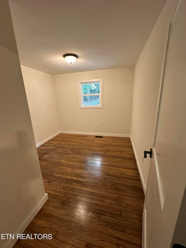 unfurnished room featuring dark hardwood / wood-style floors