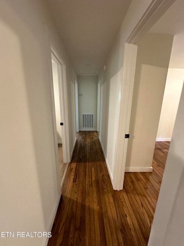 corridor featuring dark hardwood / wood-style flooring