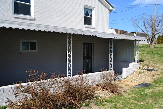 doorway to property with brick siding