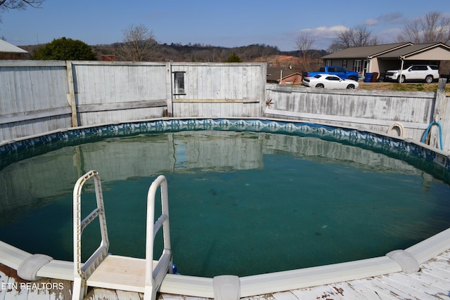 view of swimming pool with fence and a fenced in pool