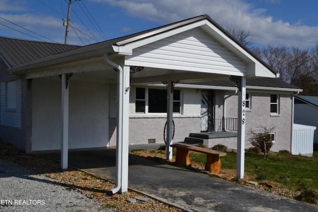 view of front of house with crawl space and brick siding