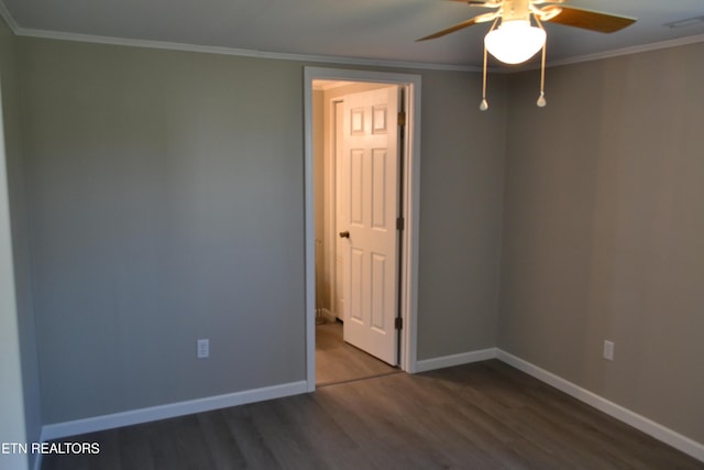 empty room featuring visible vents, crown molding, baseboards, wood finished floors, and a ceiling fan