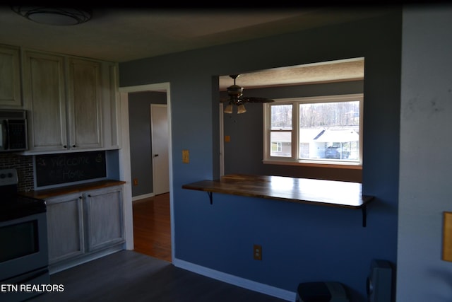 kitchen featuring range with electric cooktop, black microwave, ceiling fan, decorative backsplash, and dark wood-style floors