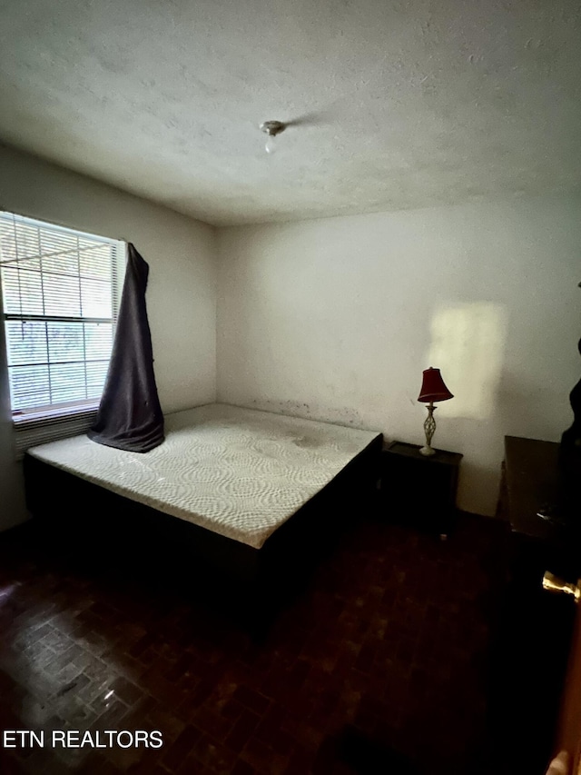 unfurnished bedroom featuring a textured ceiling