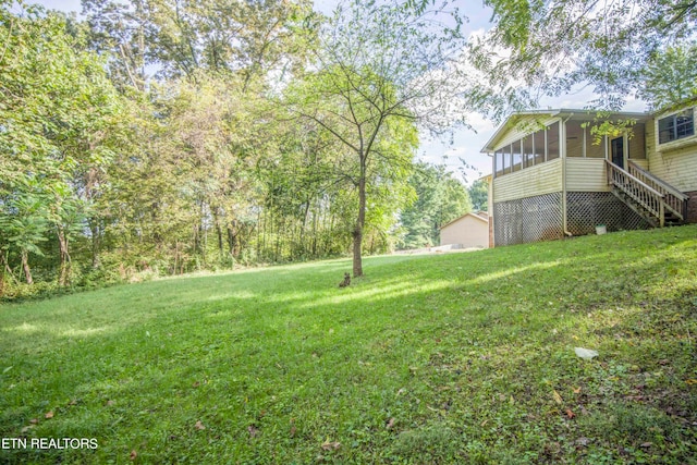 view of yard with a sunroom