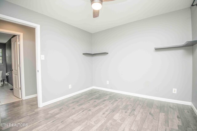 spare room featuring light hardwood / wood-style flooring and ceiling fan