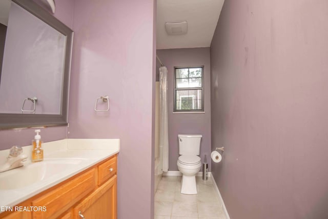 full bathroom featuring tile patterned floors, shower / tub combo with curtain, vanity, and toilet