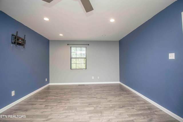 spare room with light hardwood / wood-style flooring and ceiling fan