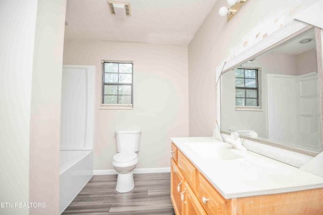 full bathroom with hardwood / wood-style floors, vanity, toilet, and plenty of natural light