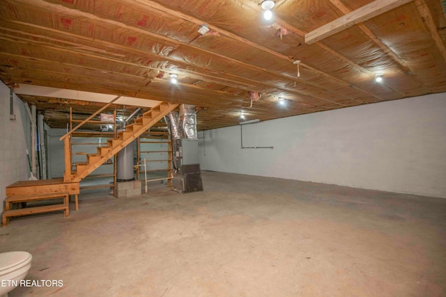 basement featuring heating unit and water heater