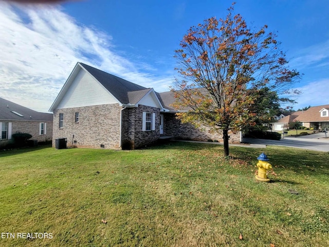 view of home's exterior with central AC unit and a lawn