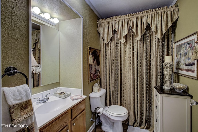 bathroom featuring a shower with shower curtain, toilet, vanity, and a textured wall