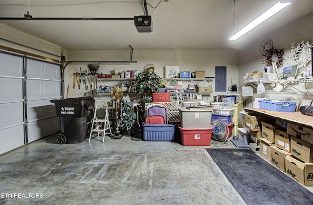 garage with electric panel and a garage door opener