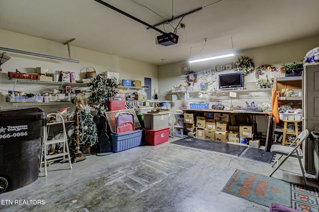 garage featuring a garage door opener and a workshop area