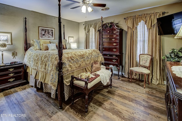 bedroom with wood-type flooring and ceiling fan