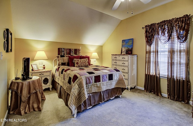 bedroom with a ceiling fan, vaulted ceiling, light colored carpet, and baseboards