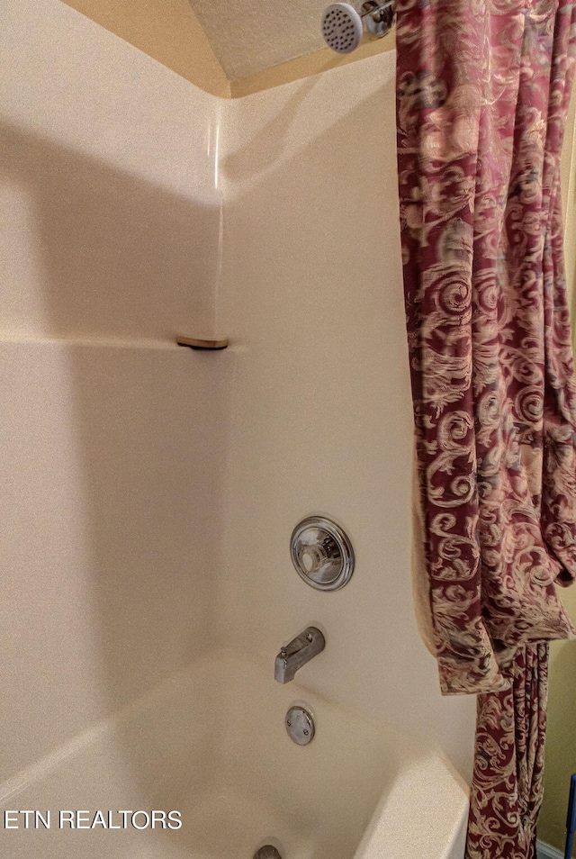 details featuring shower / bathtub combination with curtain