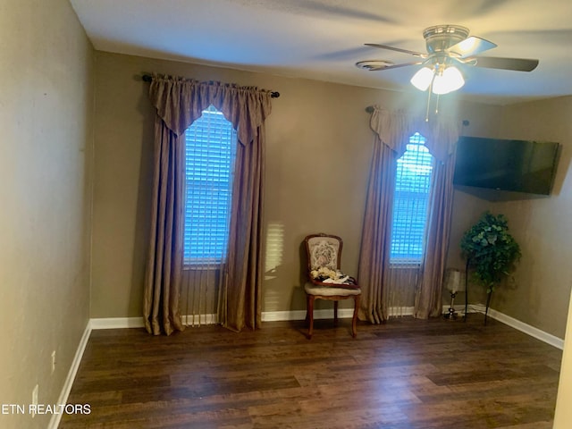 unfurnished room with wood finished floors, baseboards, and ceiling fan