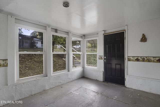 unfurnished sunroom featuring a healthy amount of sunlight