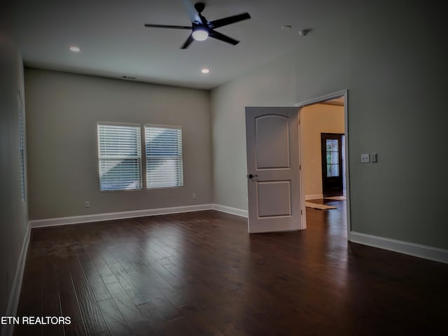 empty room featuring dark wood-type flooring and ceiling fan