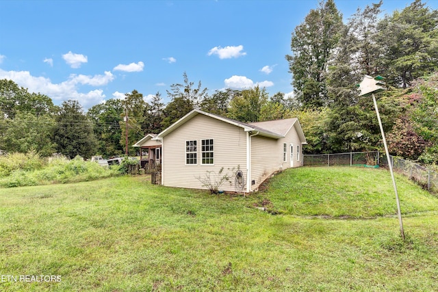 view of property exterior featuring a lawn