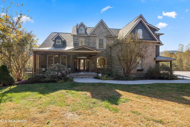 view of front facade with a front lawn and covered porch