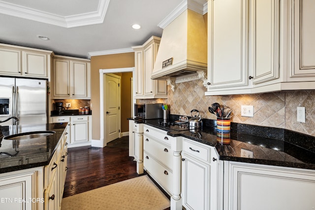 kitchen featuring custom range hood, stainless steel appliances, dark stone counters, and dark hardwood / wood-style floors