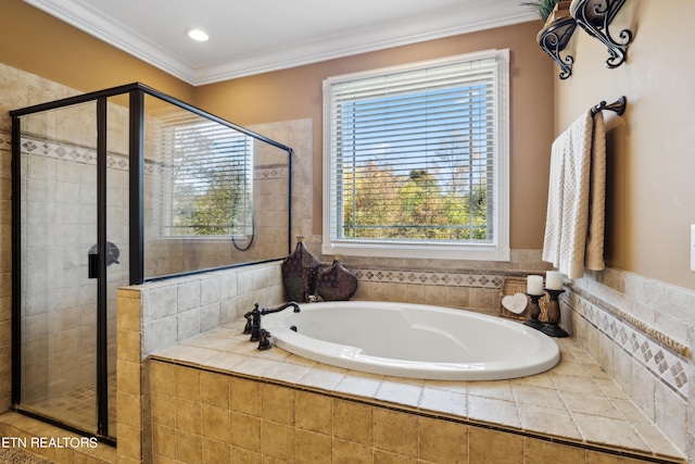 bathroom featuring ornamental molding and separate shower and tub