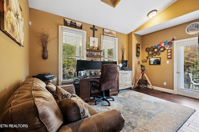 office area featuring lofted ceiling, plenty of natural light, and hardwood / wood-style floors